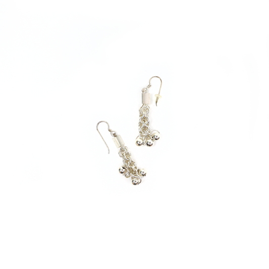 Chainmail dangle earrings with interwoven rings and ball accents displayed flat.
