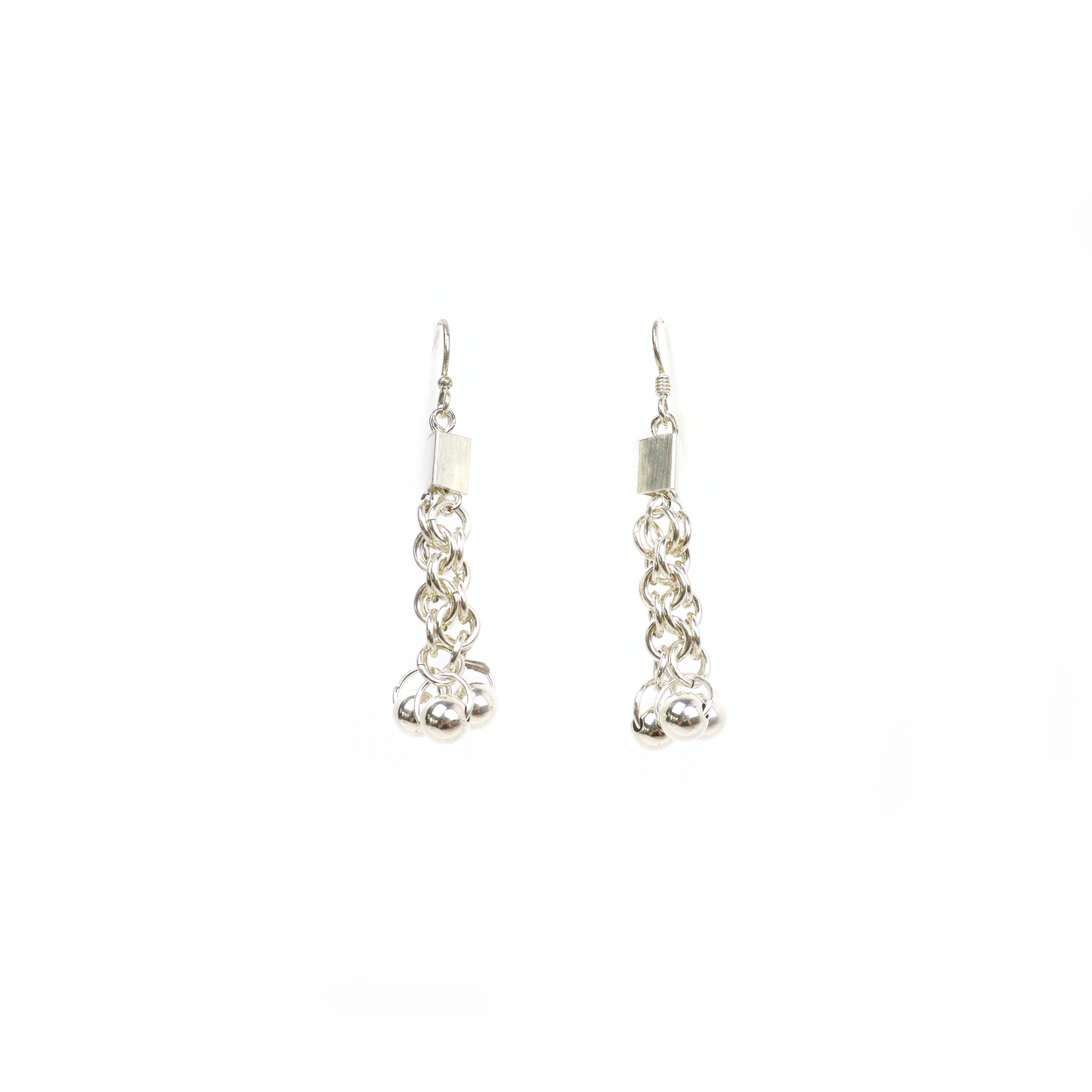 Chainmail dangle earrings shown upright, highlighting their intricate interlinked design and ball ornaments.
