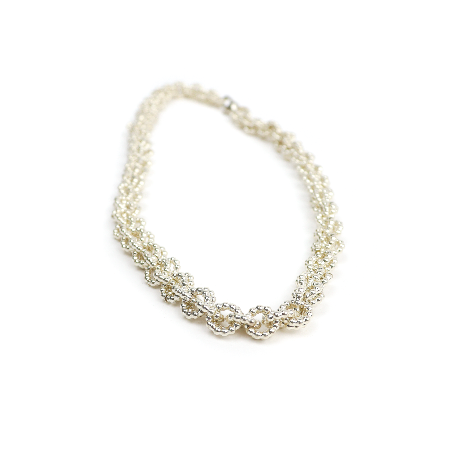 Angled view of Chain Mail Necklace highlighting the tight, elegant weave of silver rings.