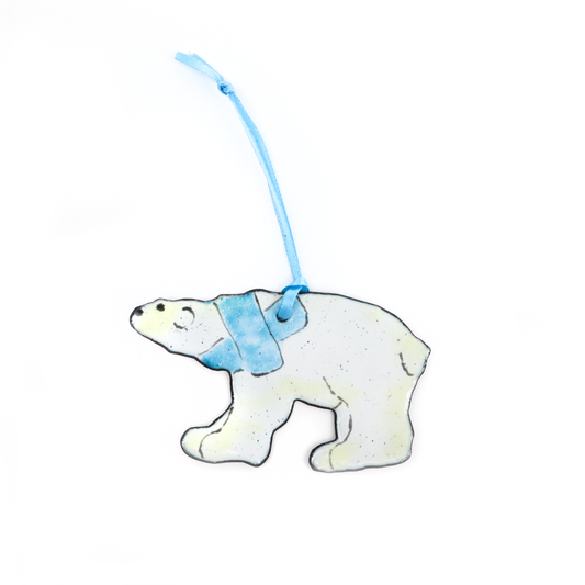 Polar bear ornament with a blue ribbon for hanging.