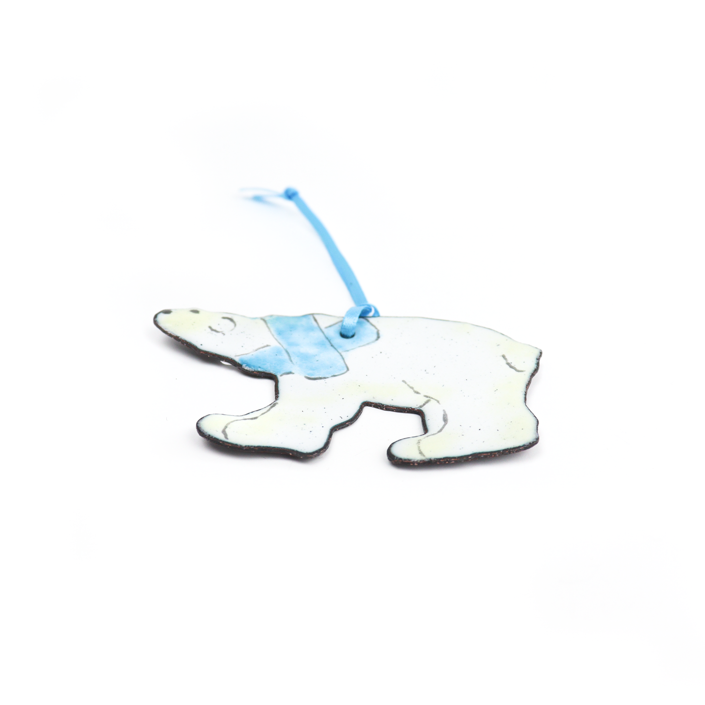 Polar bear ornament with a blue scarf and hanging ribbon.