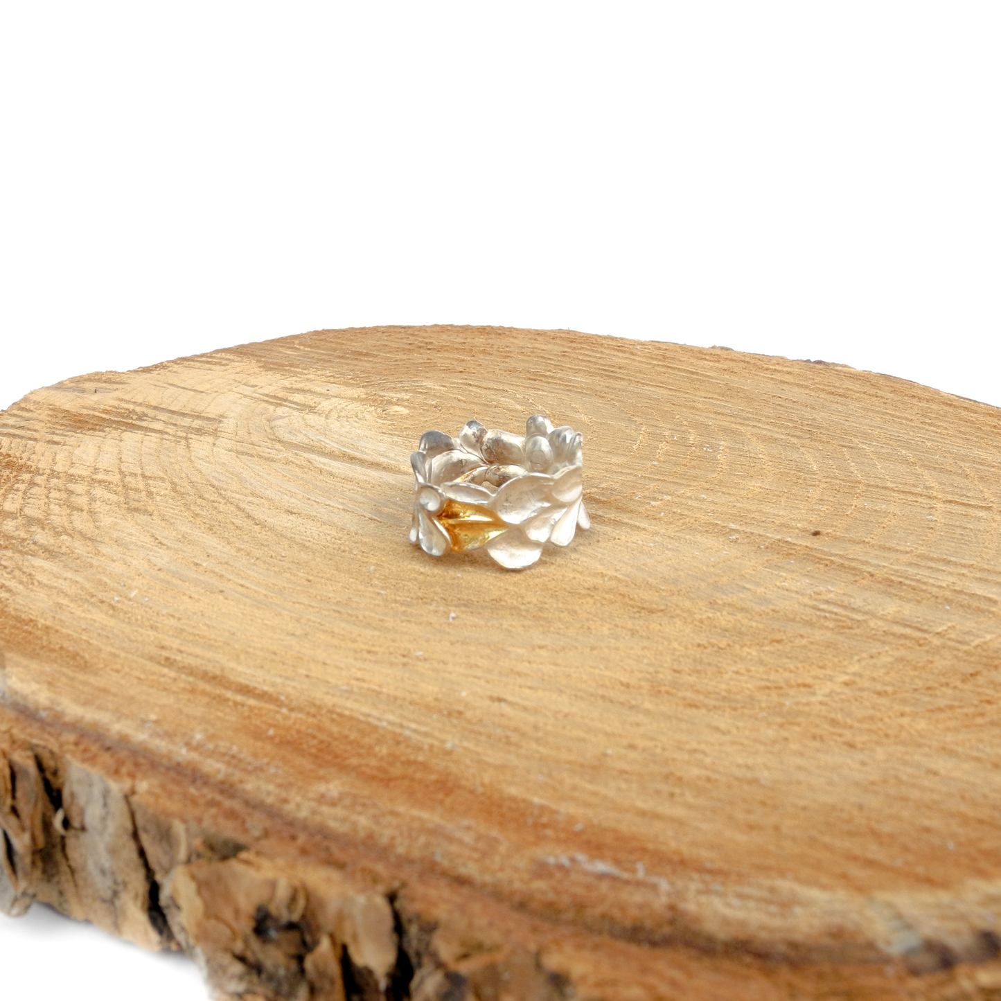 A textured sterling silver ring with abstract, overlapping petal-like shapes and a contrasting Keum-Boo gold accent.