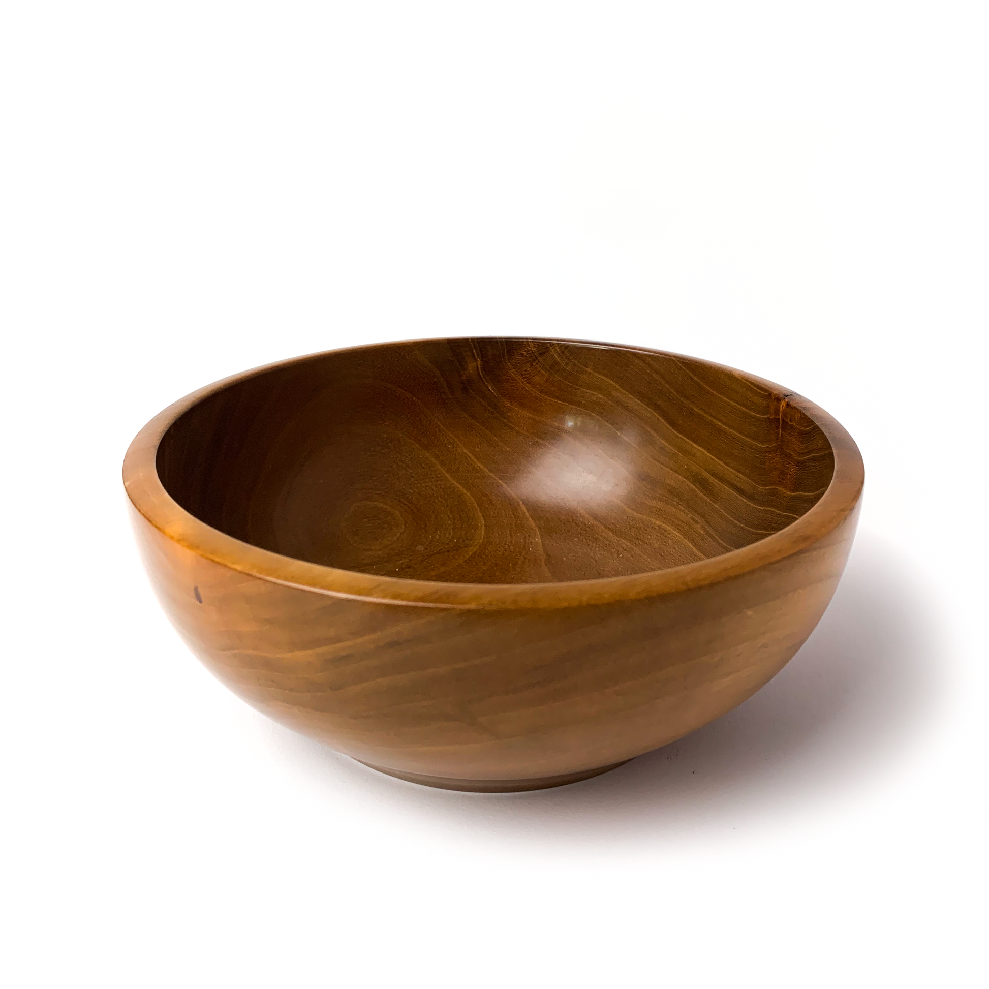 A brown wooden bowl with a smooth, rounded interior.