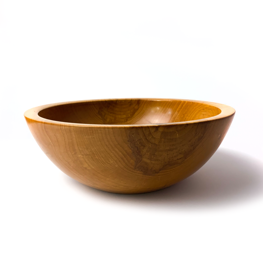 A light brown maple salad bowl with a smooth, rounded interior.