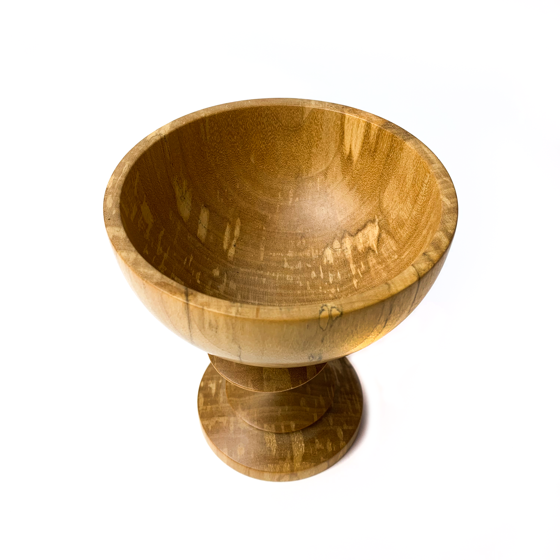 A light brown maple goblet with a rounded bowl and a short, tiered stem.