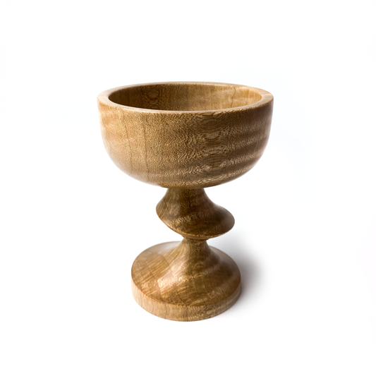 A light brown maple goblet with a twisted stem.