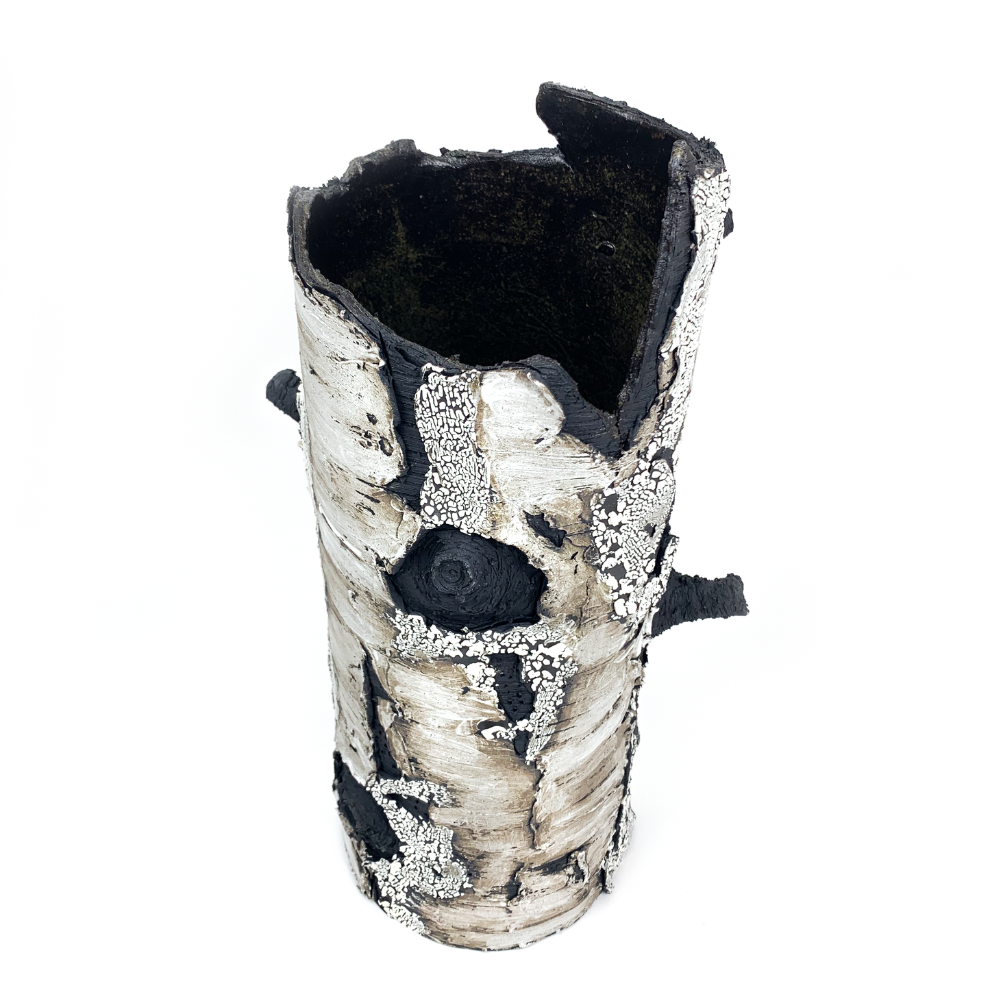 A birch bark textured vase with protruding black branches and a unique, organic shape, viewed from above.