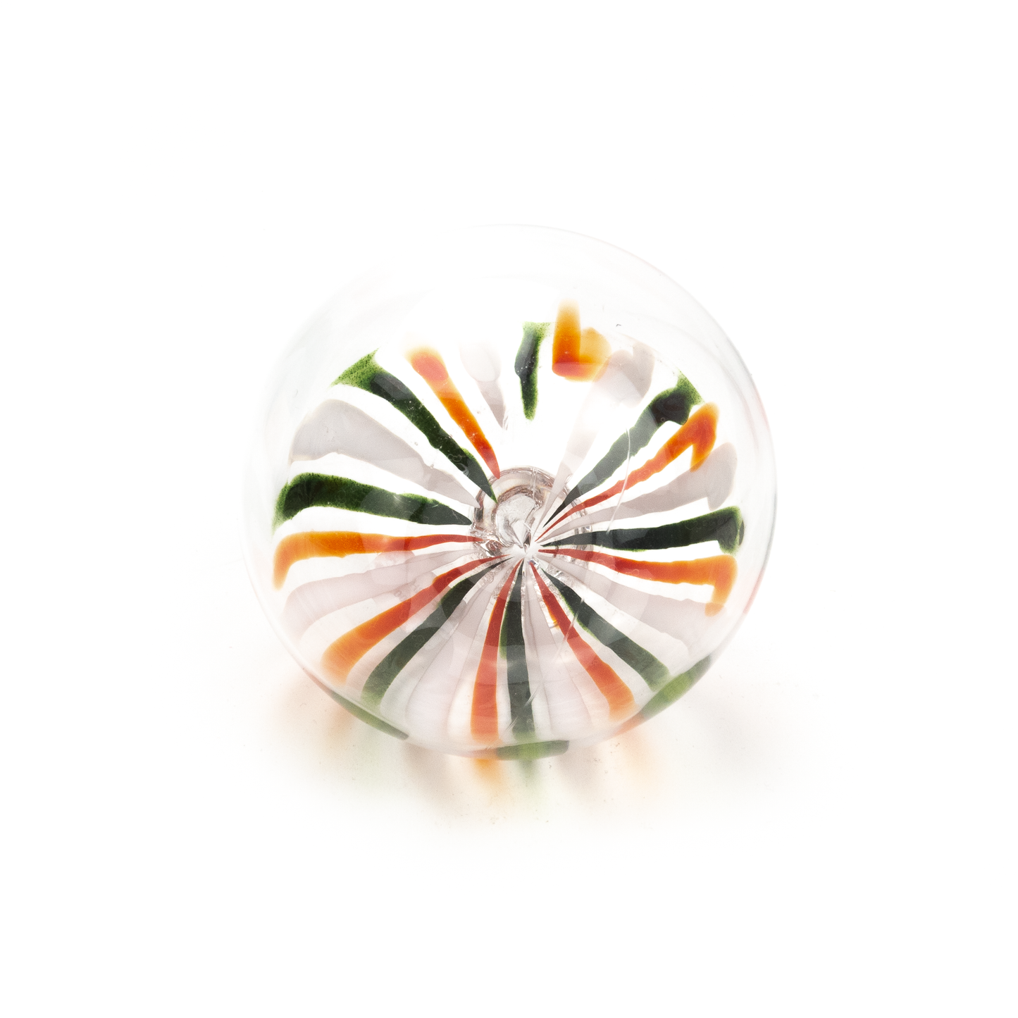 Top-down view of a round glass ornament with radiating stripes of red, green, and white converging at the center.