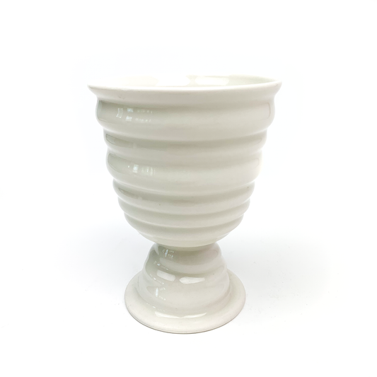 A ridged ceramic goblet with a wide bowl, short stem, and flared circular base.