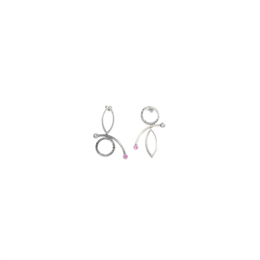 A pair of abstract metallic earrings with circular, oval, and curved elements, accented with small pink and clear stones.