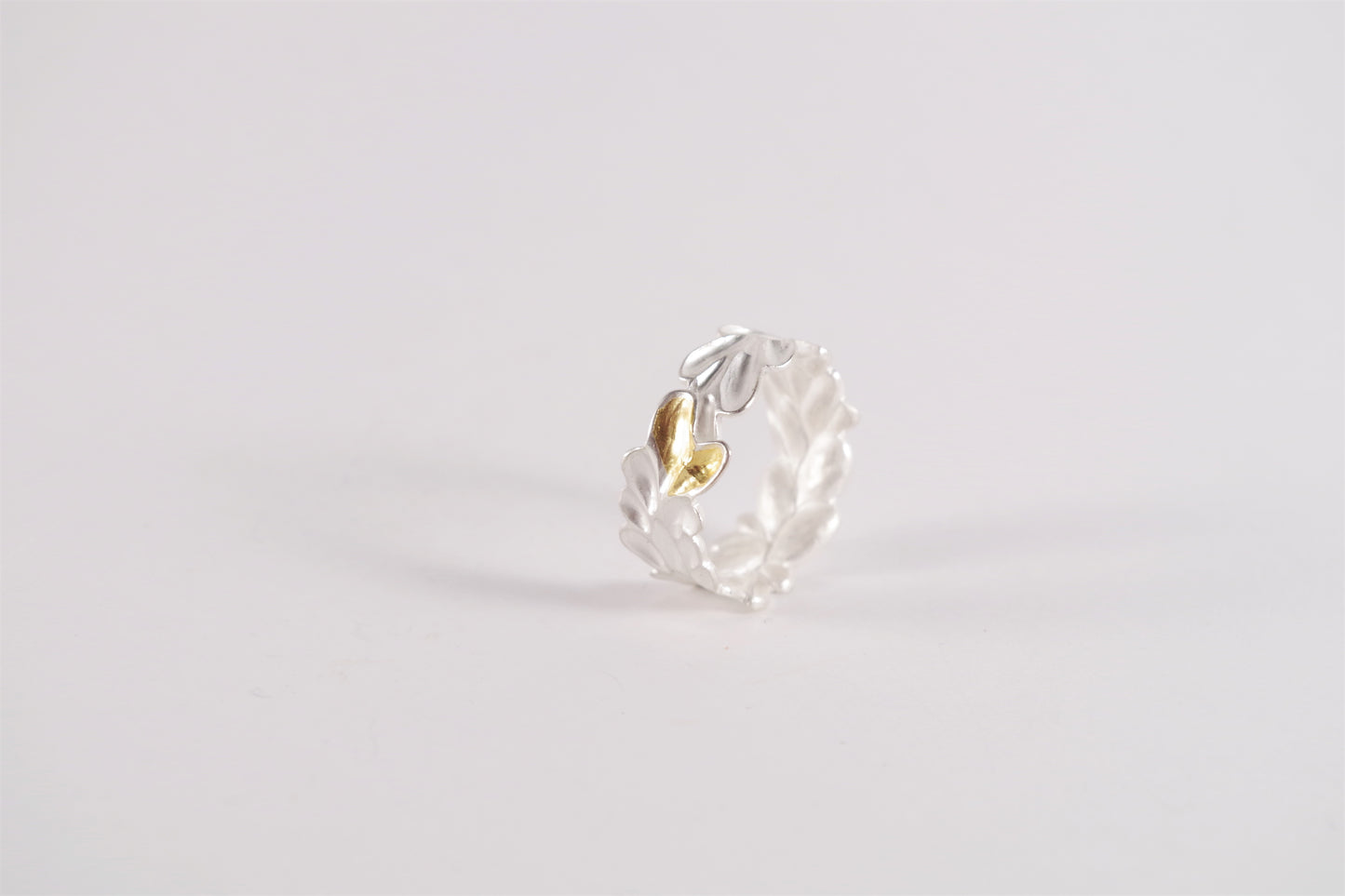A sterling silver ring with a textured, abstract leaf or petal design and a single Keum-Boo gold accent.