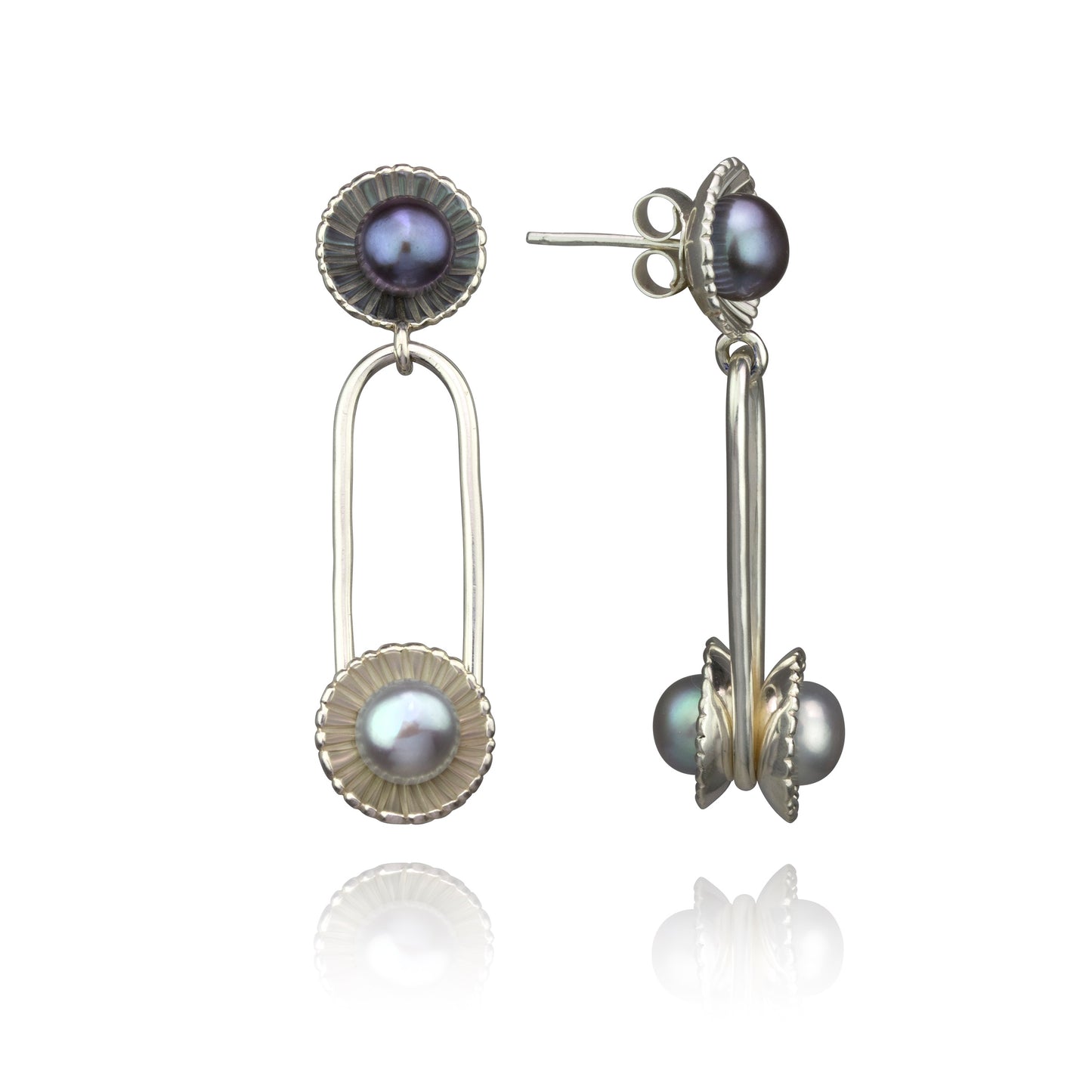 Two Edna Milevsky mismatched silver drop earrings with iridescent pearls in textured settings.
