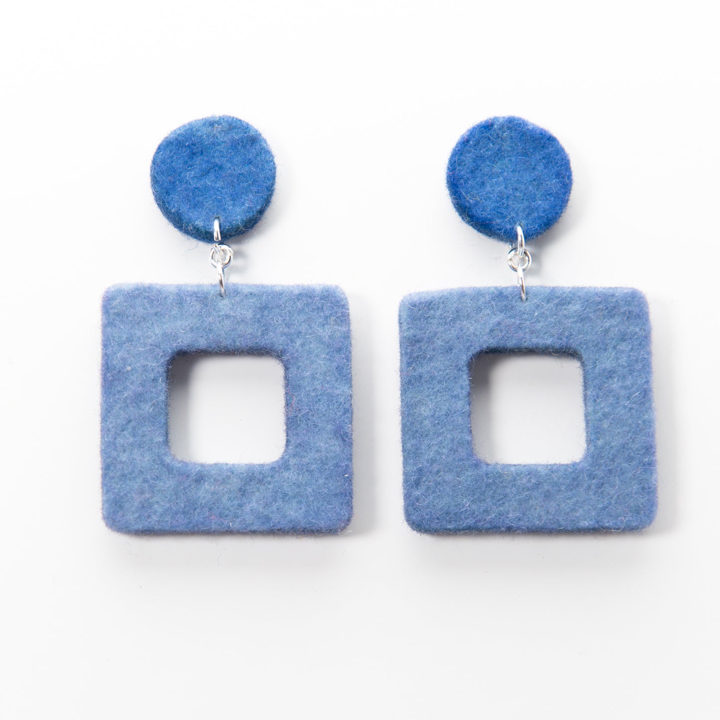 Two blue felt earrings with silver hooks. Each earring features a small circle above a larger square.