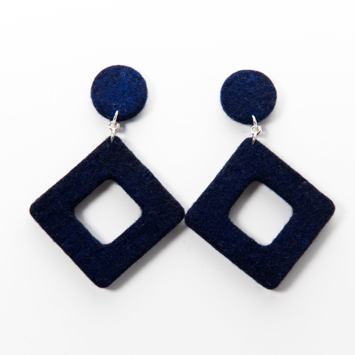 Two navy, fuzzy geometric earrings: circles on top, hollow squares dangling below.