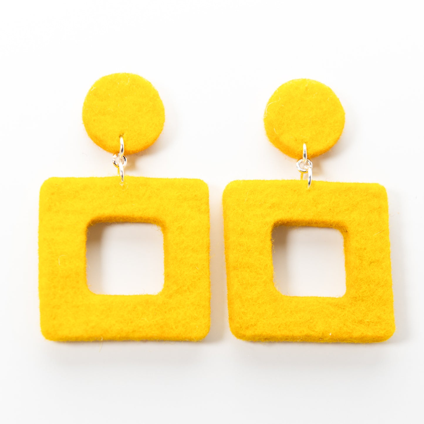 Two bright yellow, fuzzy geometric earrings: circles on top, hollow squares dangling below.