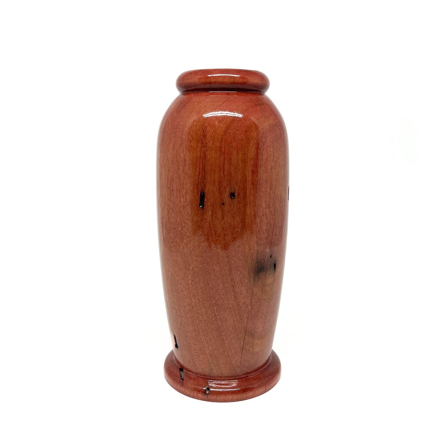 Small, polished wooden urn with a warm, reddish-brown tone and subtle natural wood markings.
