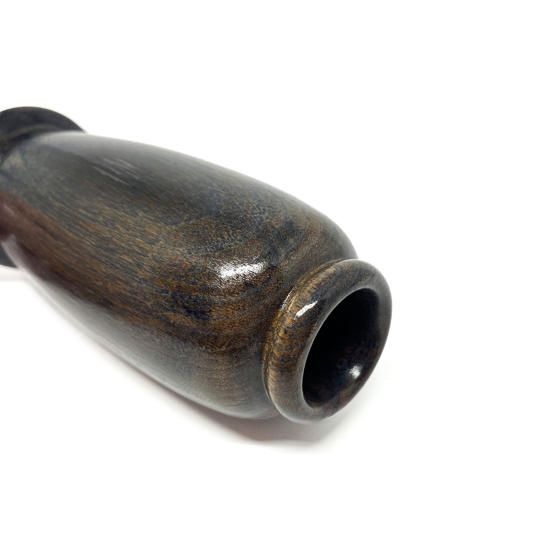 Close-up of the polished opening and side of a dark wooden vase with visible wood grain.