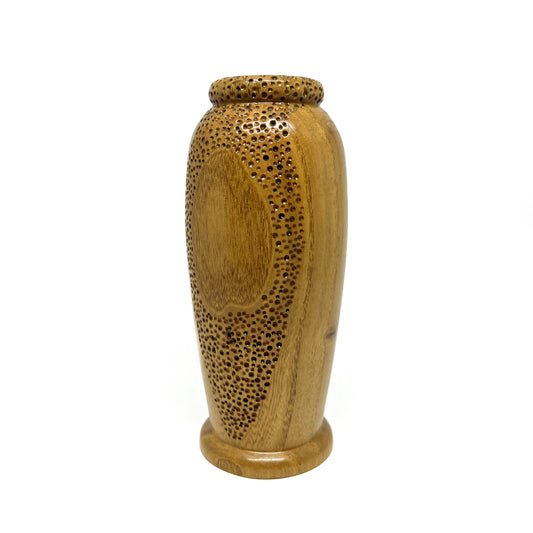 Small wooden vase with a textured surface featuring carved circular patterns and small perforations.