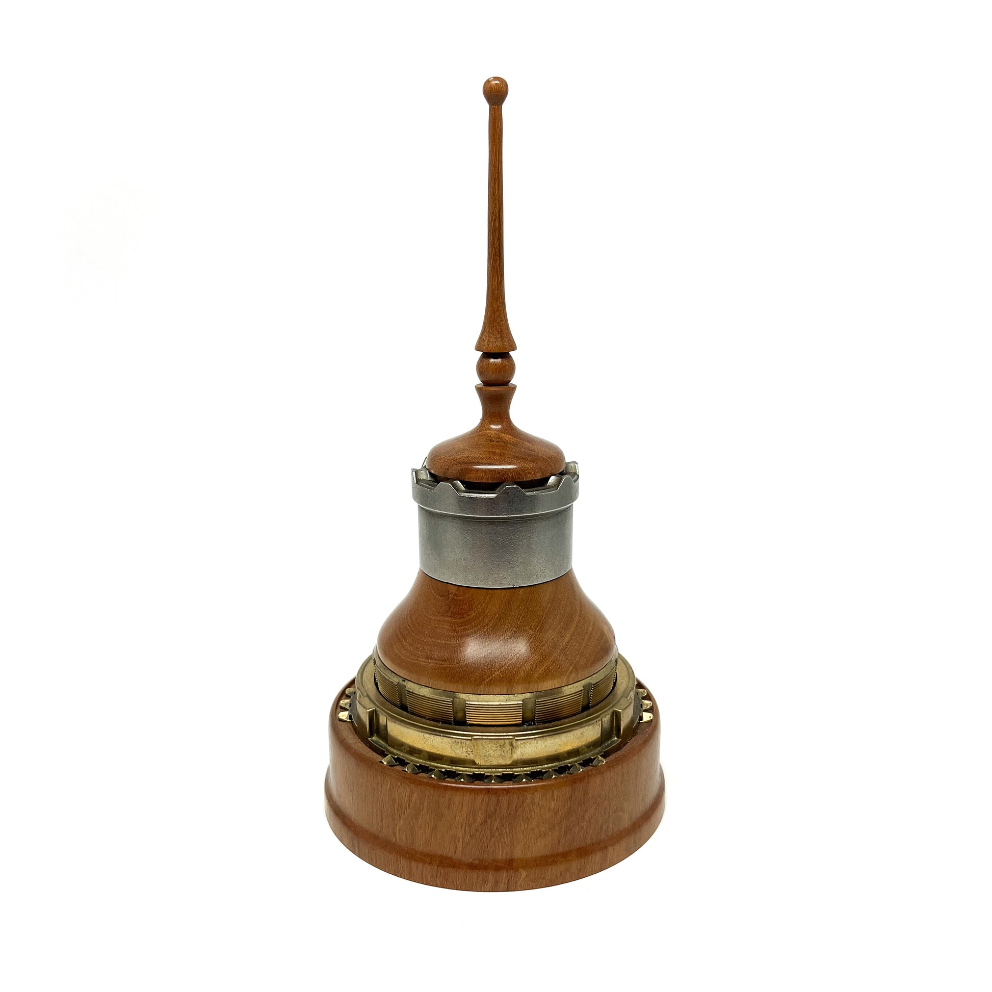 Wooden mixed media sculpture with a spire, metal accents, and intricate detailing.