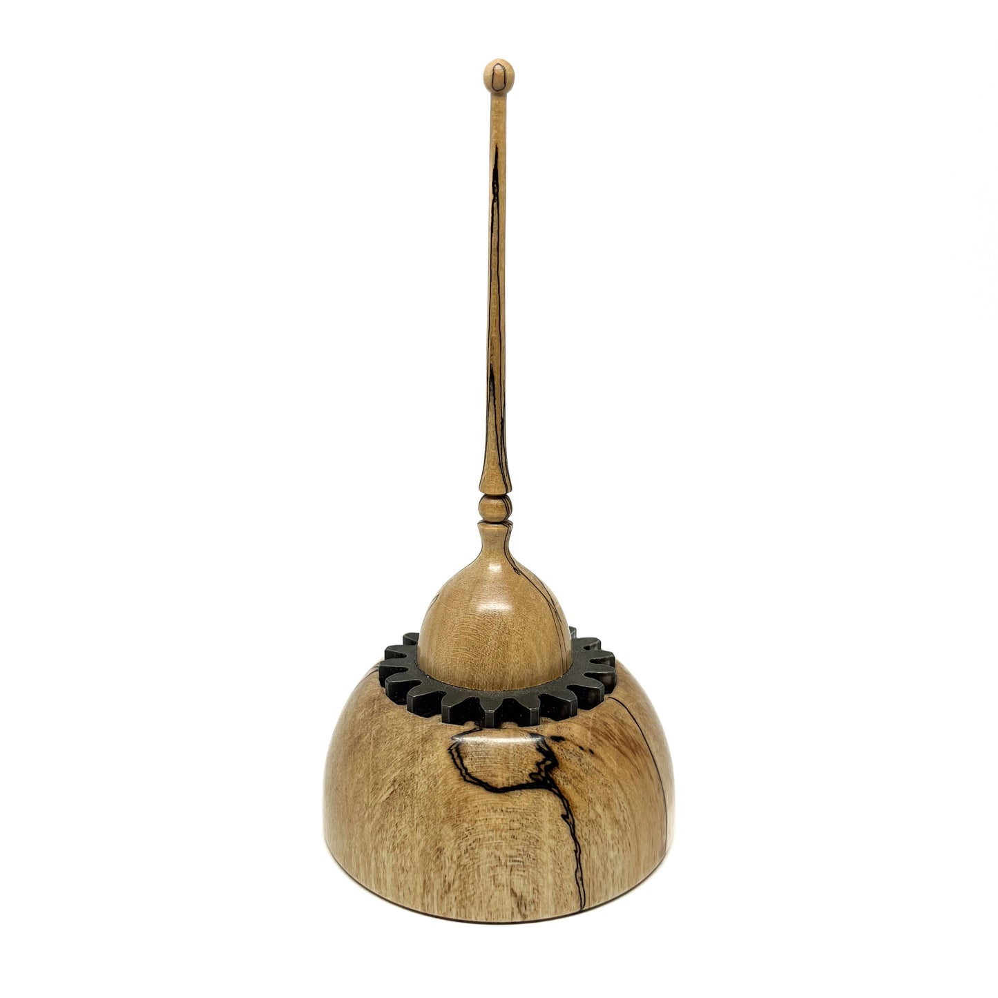 Small wood spire sculpture by David Adolph with a cog-like ring and a tall, slender, topped spire.
