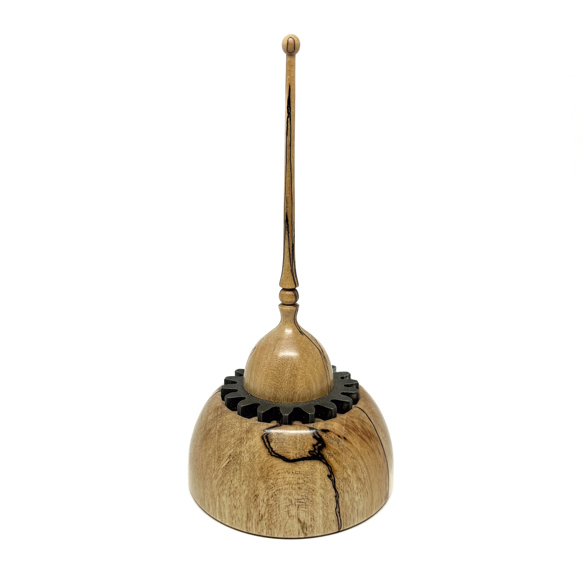 Small wood spire sculpture by David Adolph with a cog-like ring and a tall, slender, topped spire.