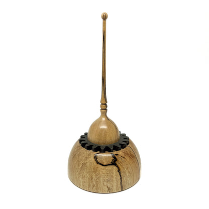 Small wood spire sculpture by David Adolph with a cog-like ring and a tall, slender, topped spire.