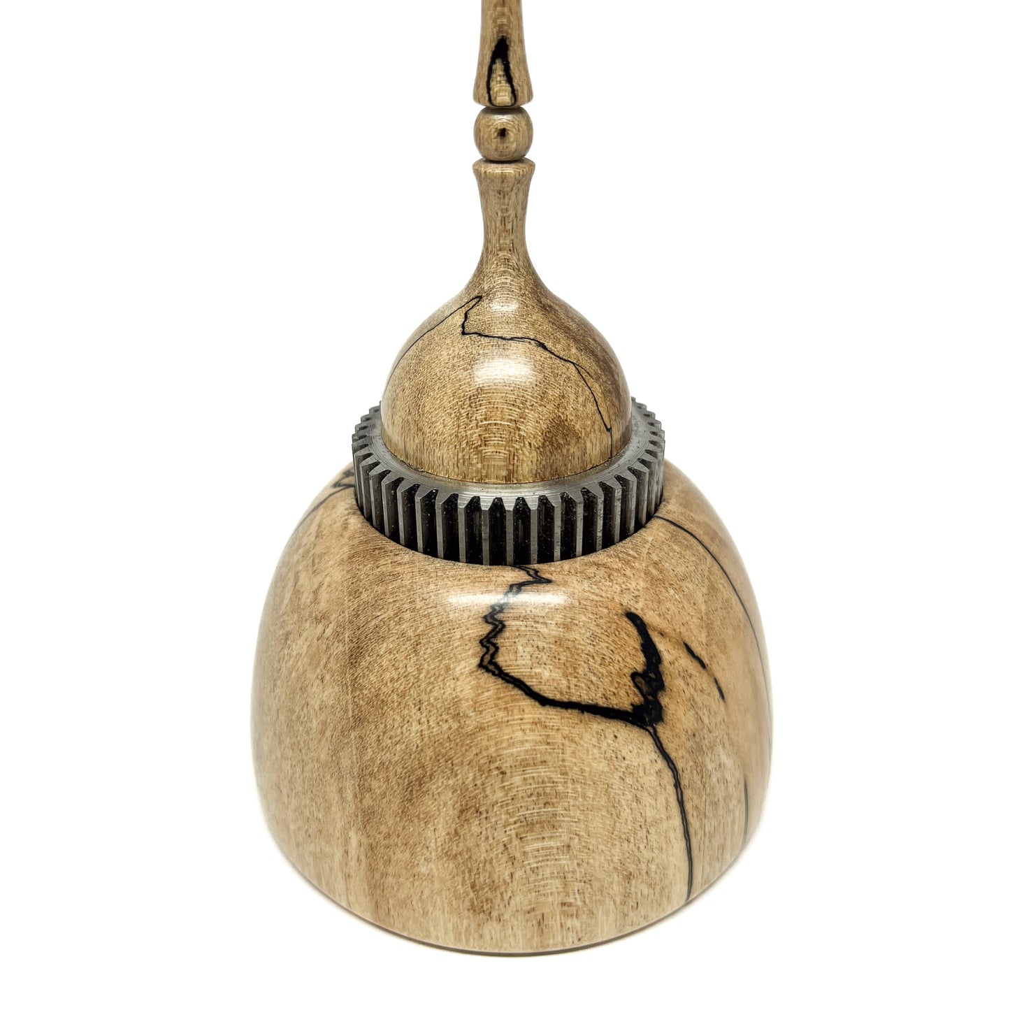 Close-up of a small wood spire sculpture with a textured metal ring and a tall, slender, detailed spire.