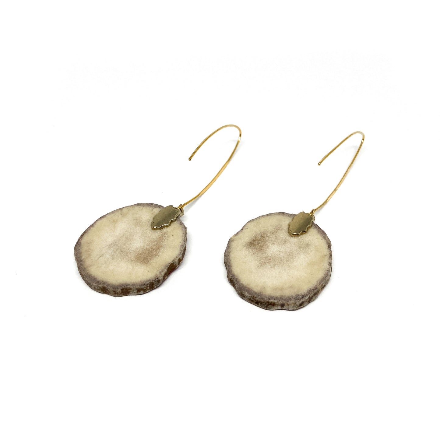Two round earrings made from slices of antler, featuring gold caps and hooks.