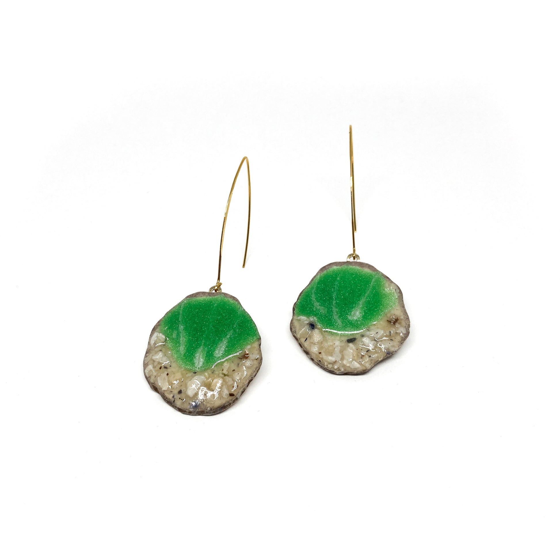 Two round earrings with green and white geode-like designs, featuring gold hooks.