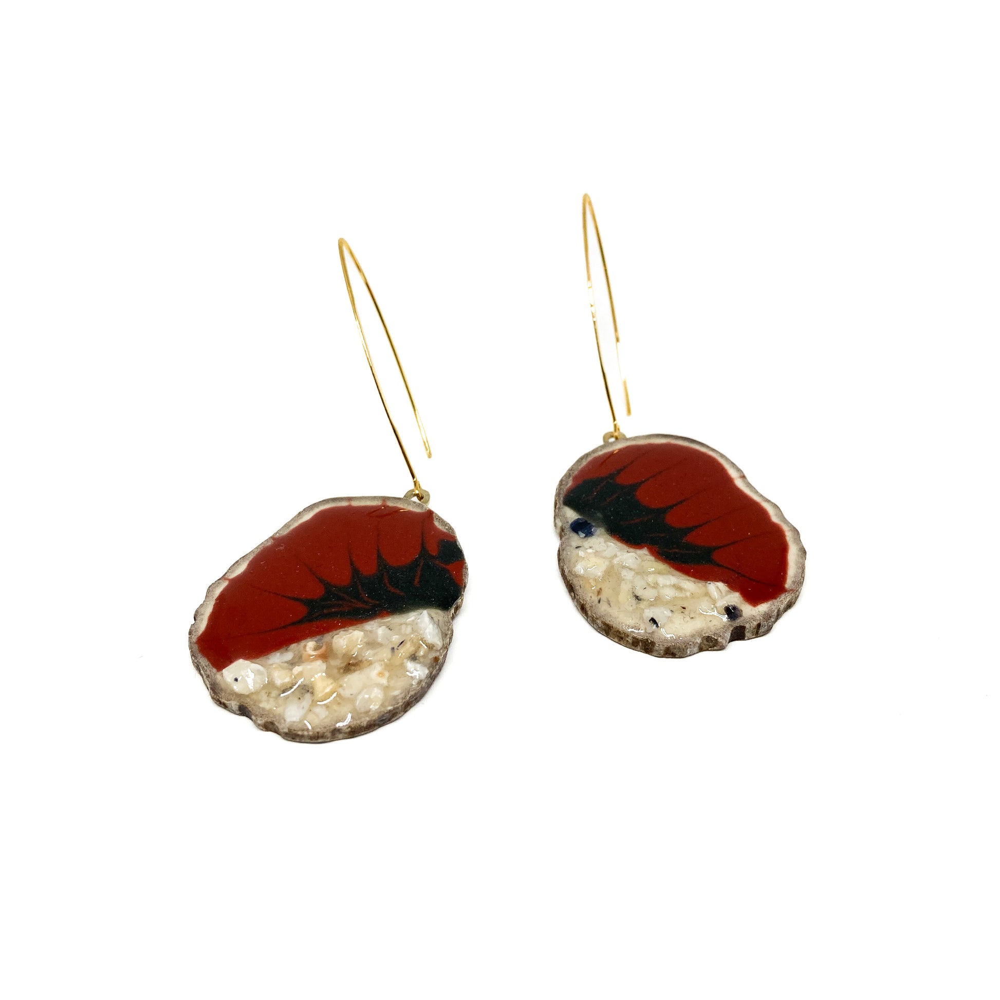 Two round earrings with red and black bird-shaped designs, featuring gold hooks.
