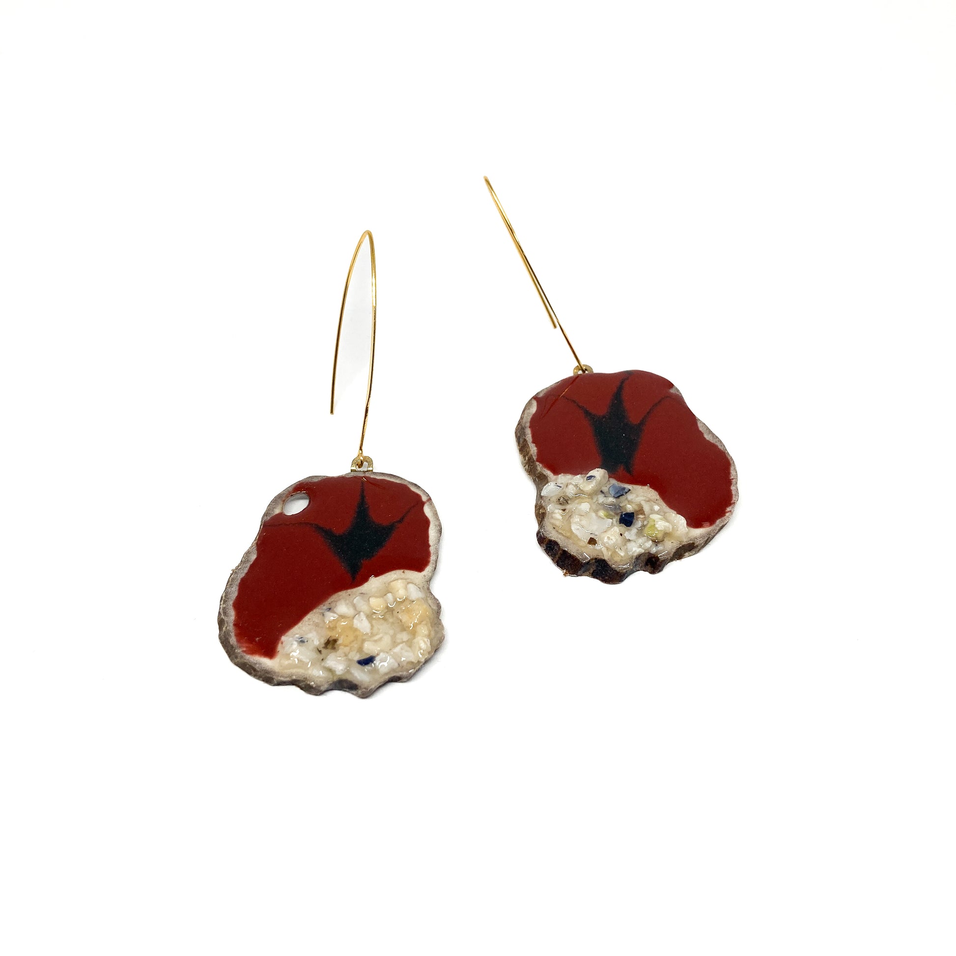 Two round earrings with red and black bird-shaped designs, featuring gold hooks.