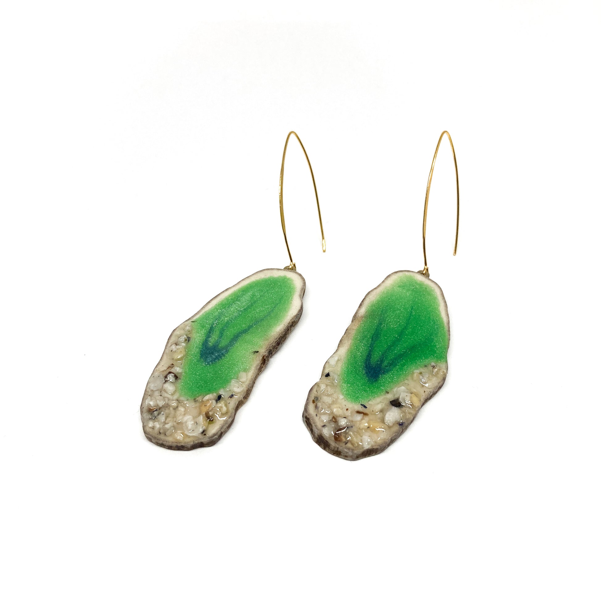 Two round earrings with green geode-like designs, featuring gold hooks.