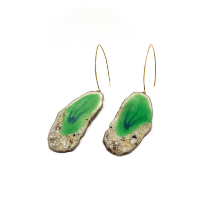Two round earrings with green geode-like designs, featuring gold hooks.