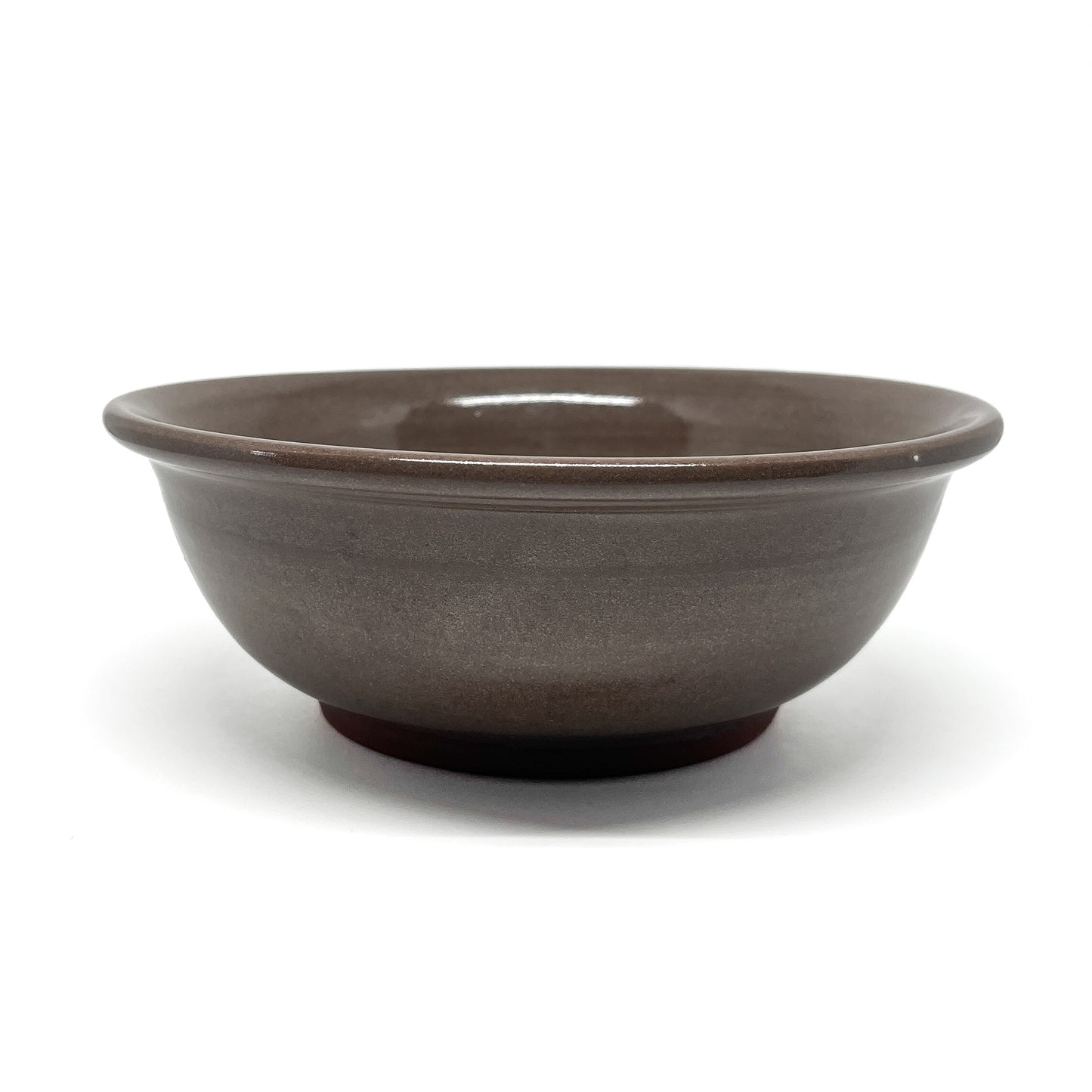 Top view of a bowl featuring two carved squid in mirrored positions, framed within a circular border.