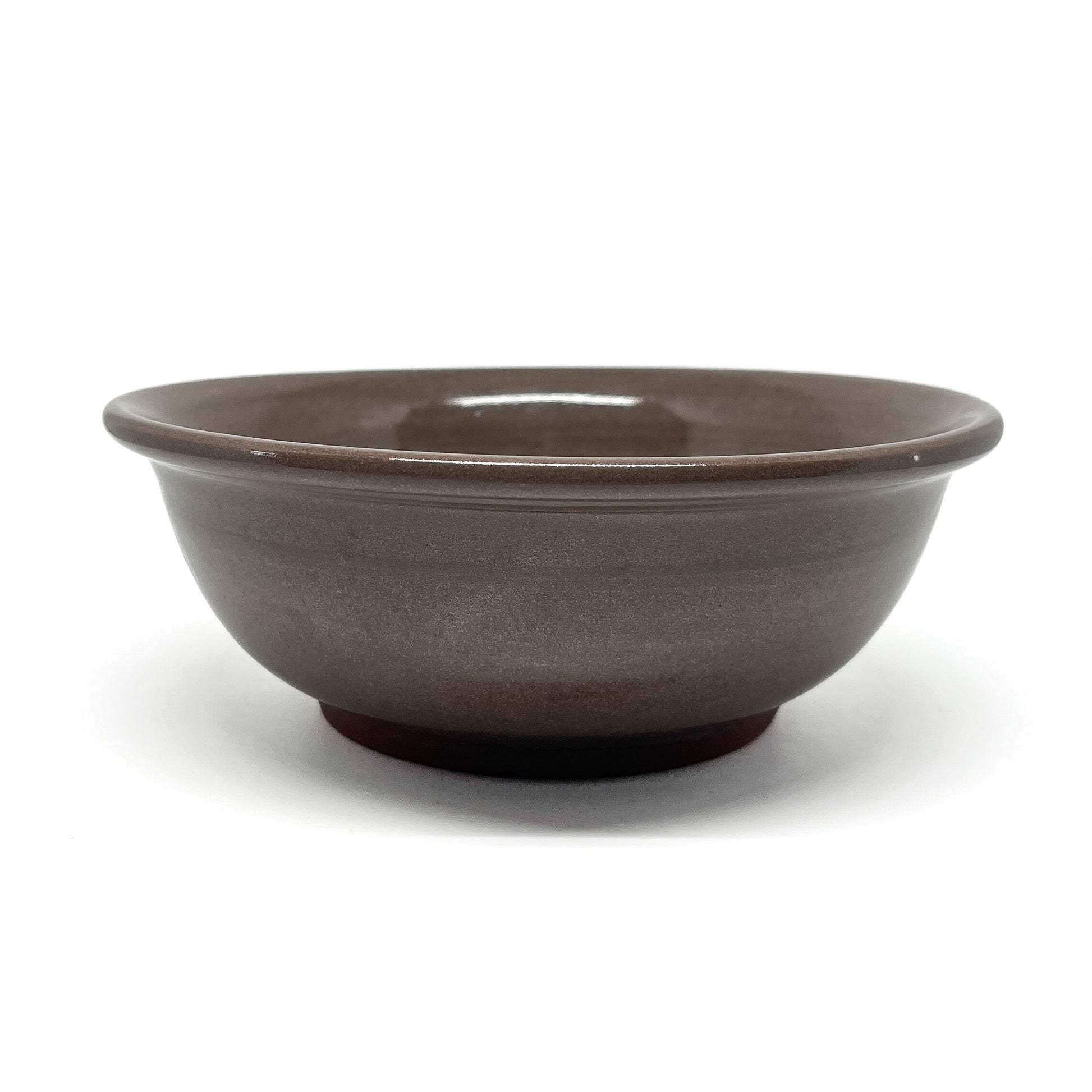 Top view of a bowl featuring two carved squid in mirrored positions, framed within a circular border.
