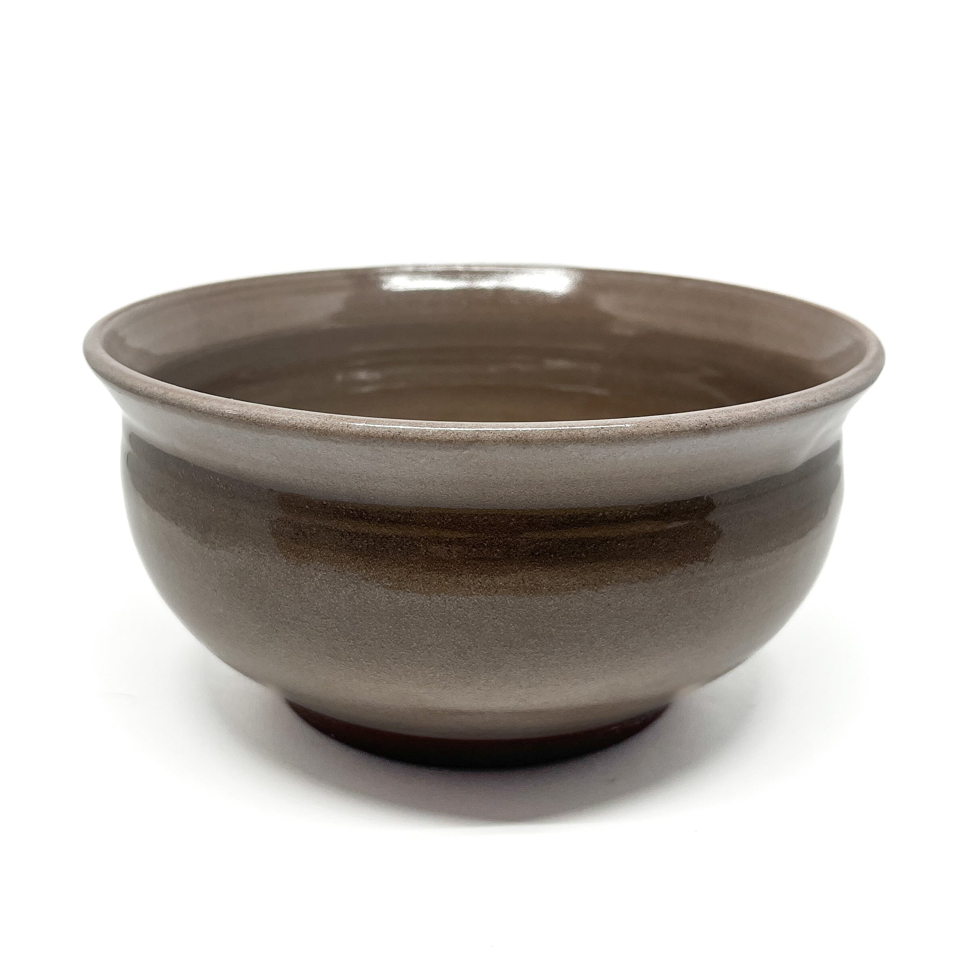 Side view of a ceramic bowl with a smooth, glossy finish and a slightly flared rim.