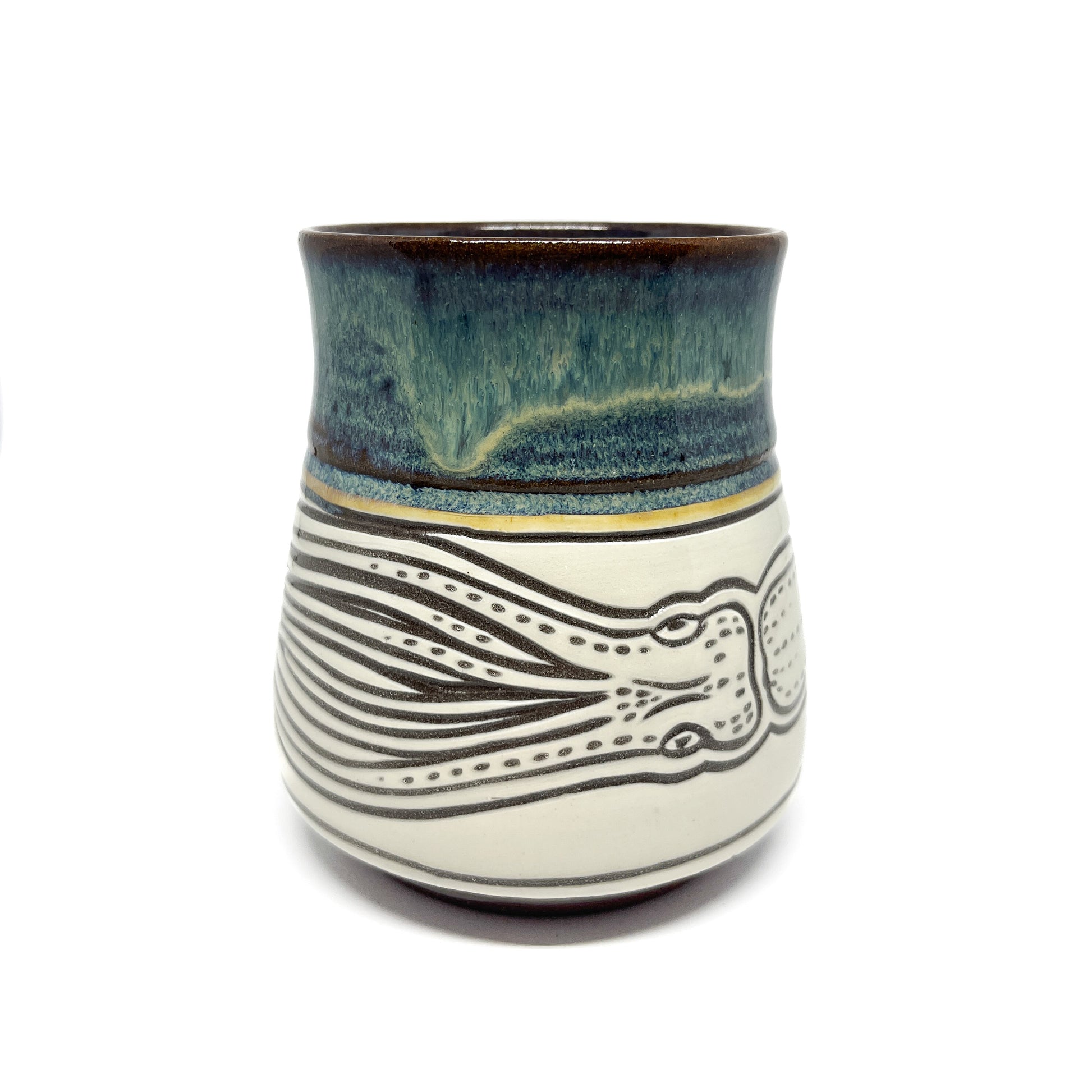 Side view of ceramic mug with partial octopus design, showing detailed carved tentacles.