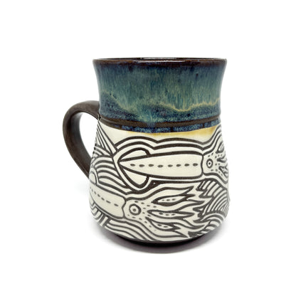 Ceramic mug with full octopus illustration, featuring swirling tentacles and a glazed top.