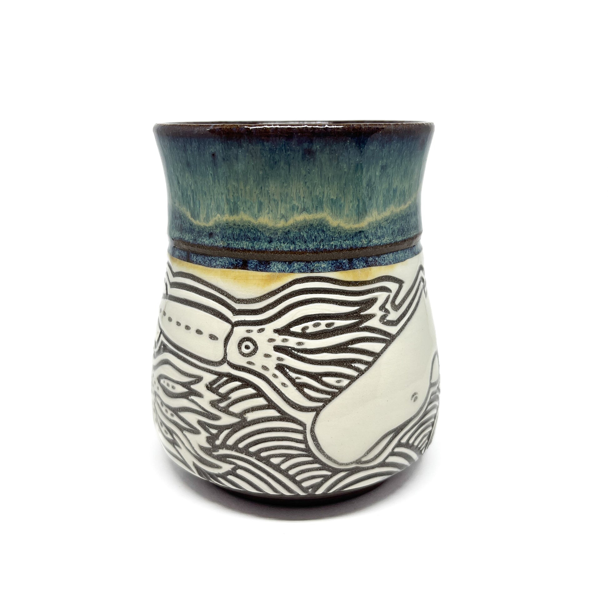 Back view of mug with detailed squid and whale illustrations above stylized ocean waves.