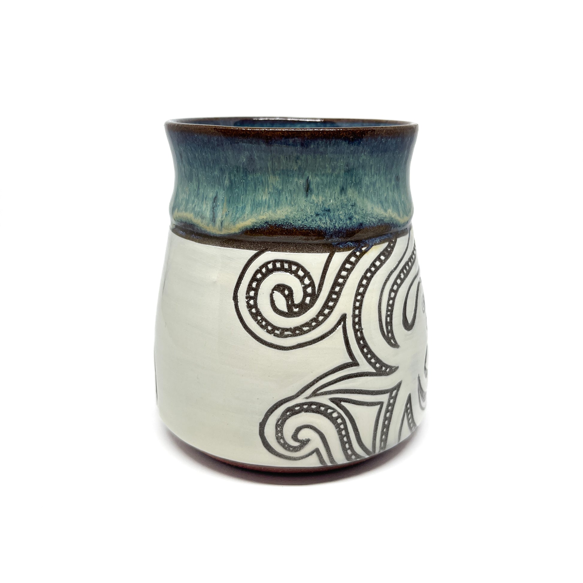 Rear view of ceramic mug featuring an elongated squid with finely detailed tentacles.