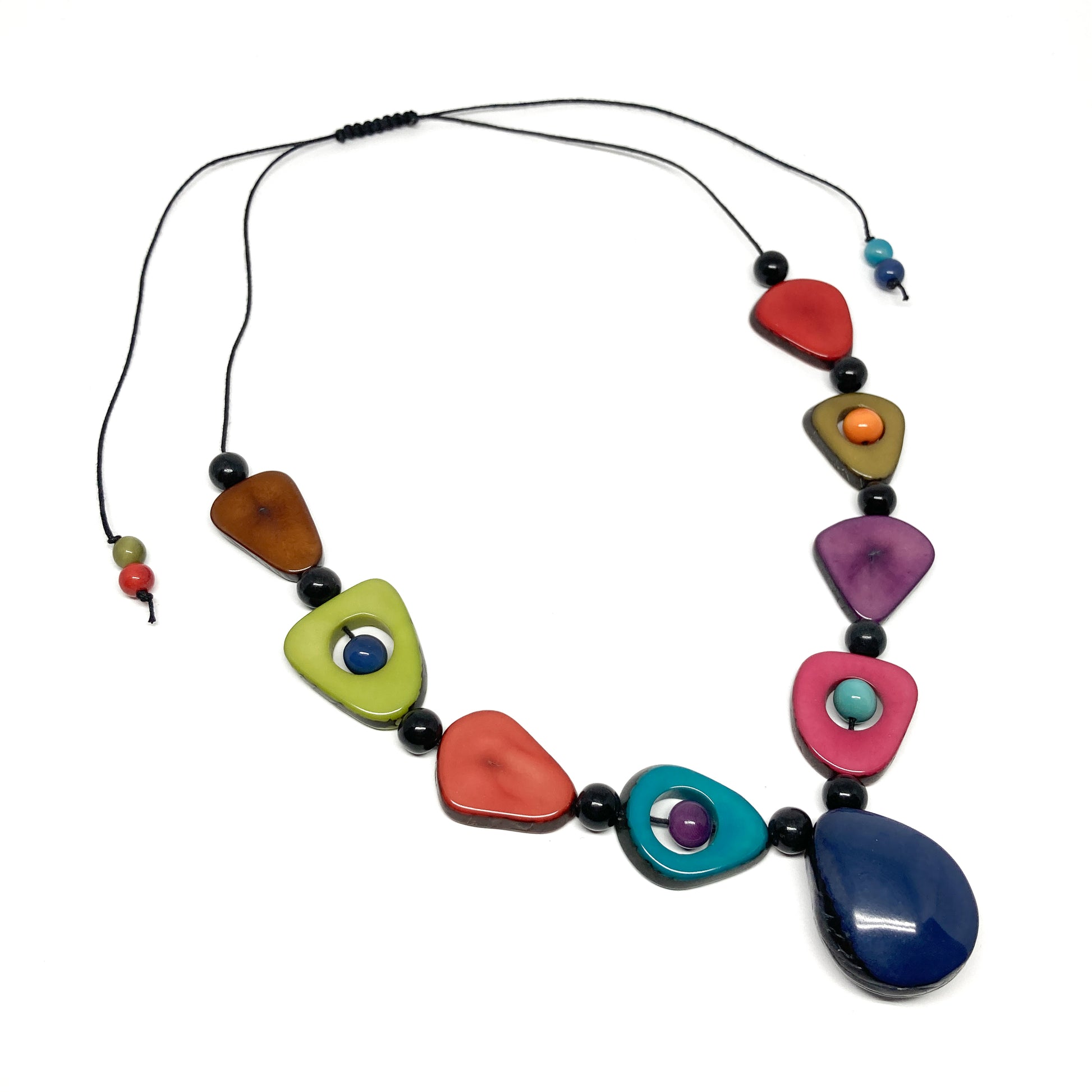 A necklace with colorful, irregularly shaped stones and black beads on a thin black cord.