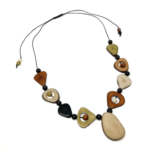 A necklace with irregularly shaped, earth-toned stones and black beads on a thin black cord.