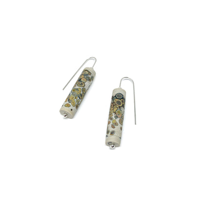 Two cylindrical earrings with multi-colored speckled dots, silver hooks, and small silver beads.