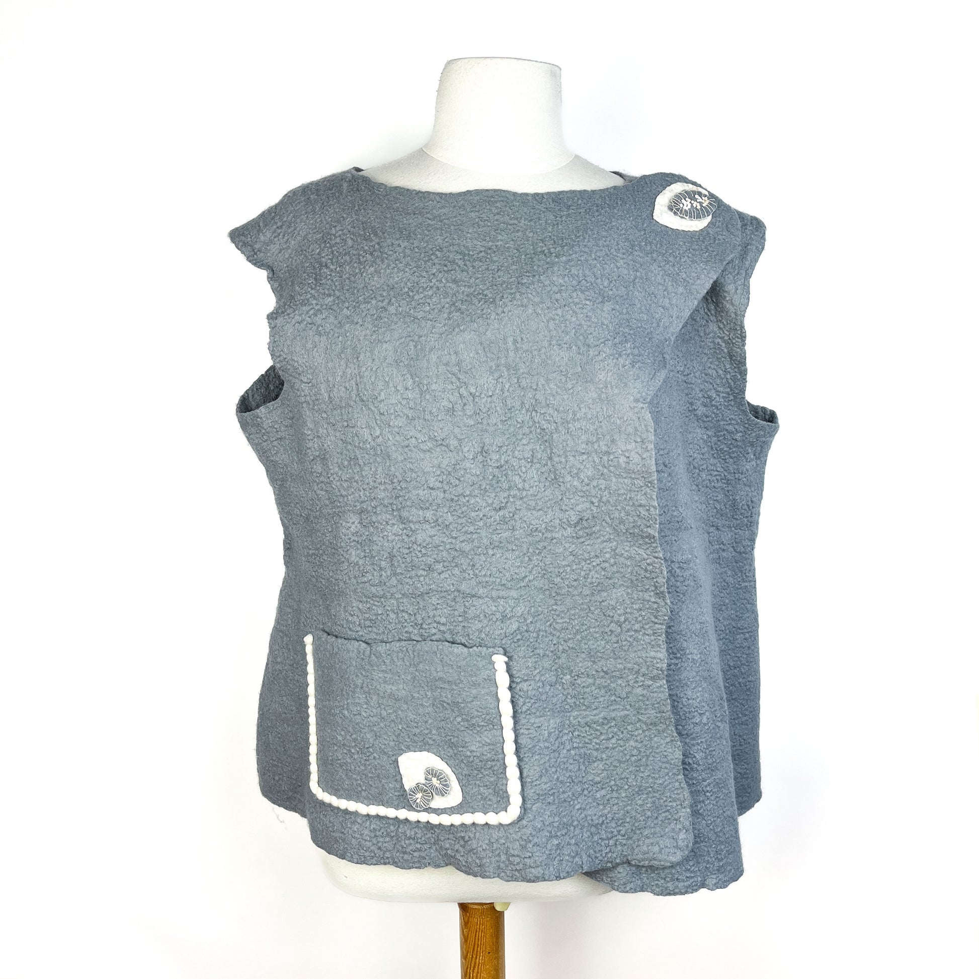 Gray Merino Wool Vest with Cotton Yarn Detail and a pocket with decorative stitching and button.