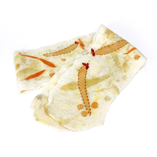 White eco-print scarf with abstract orange and yellow leaf-like designs and red accents.
