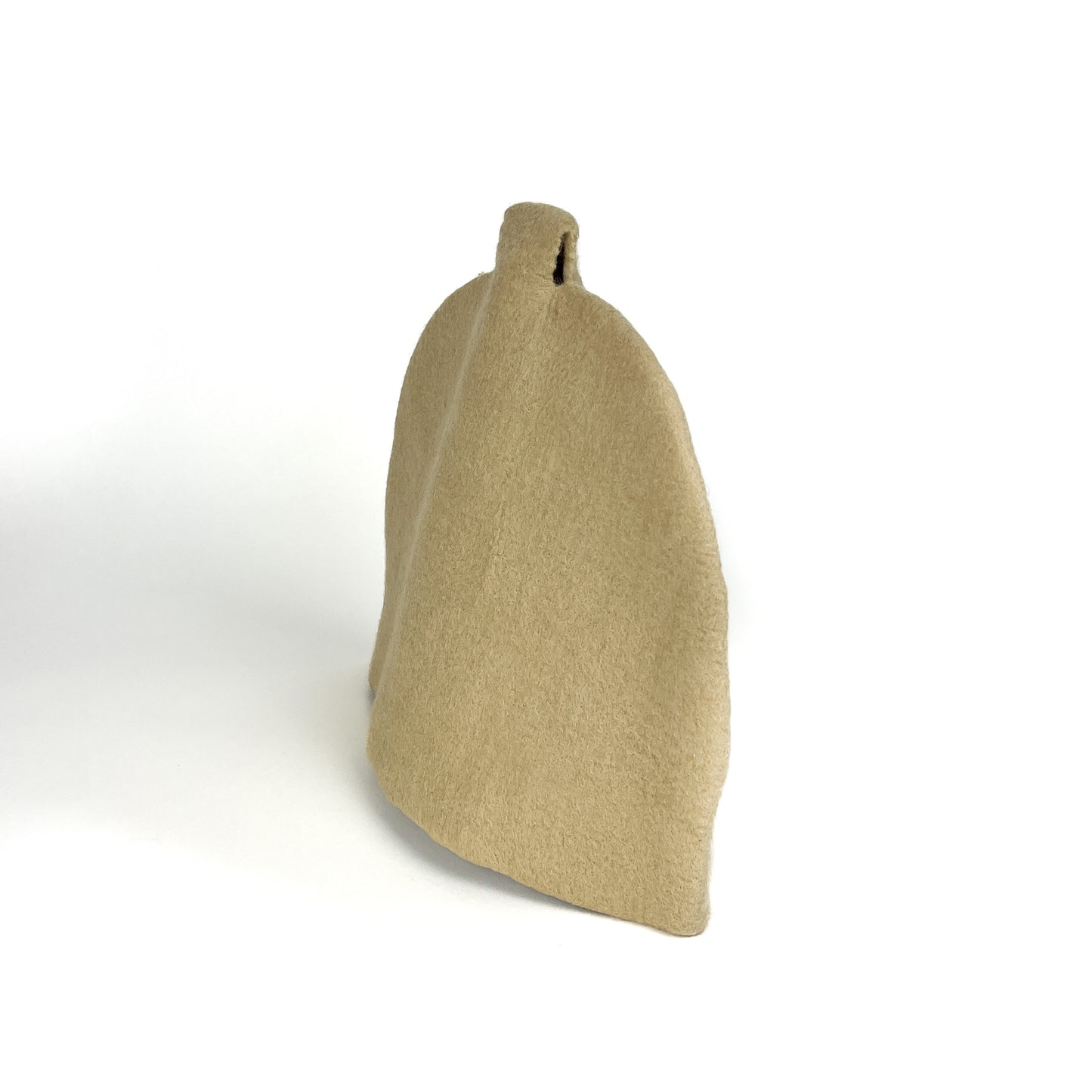 Plain beige felted teapot cozie with a simple, rounded shape and spout opening.