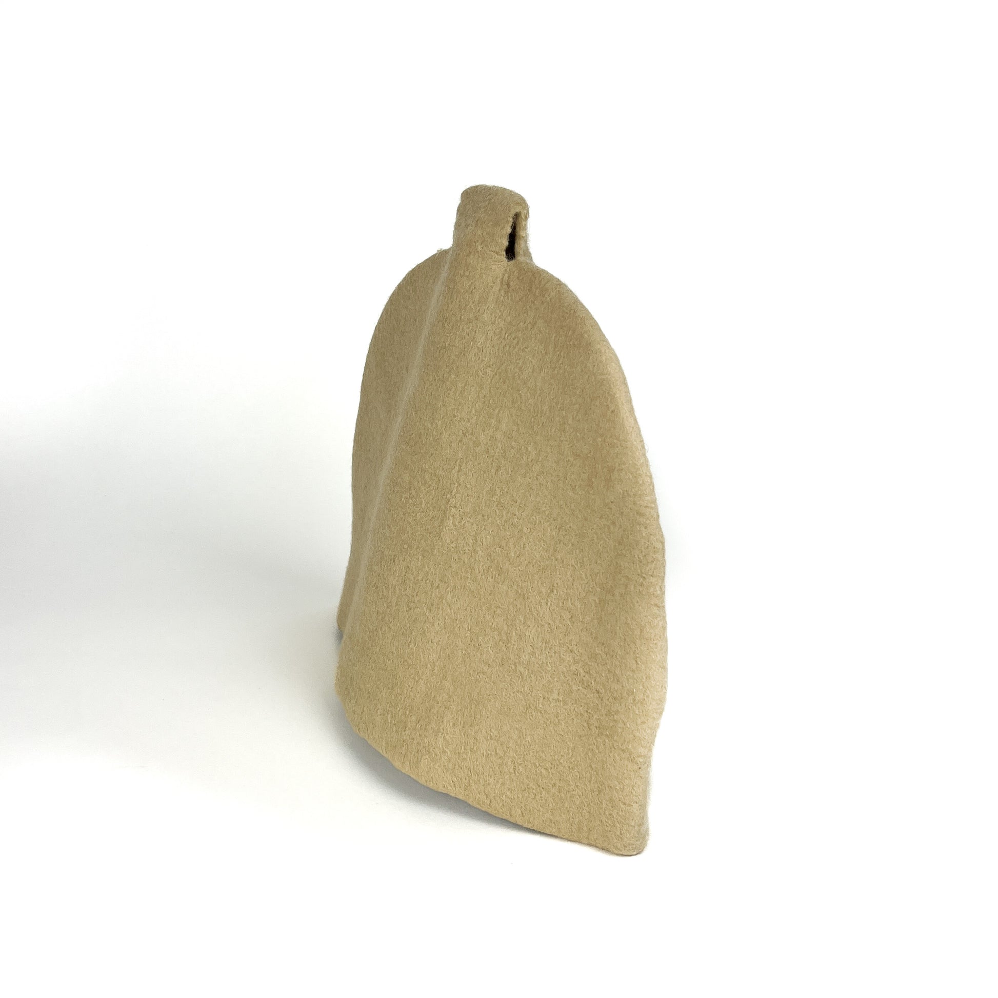 Plain beige felted teapot cozie with a simple, rounded shape and spout opening.