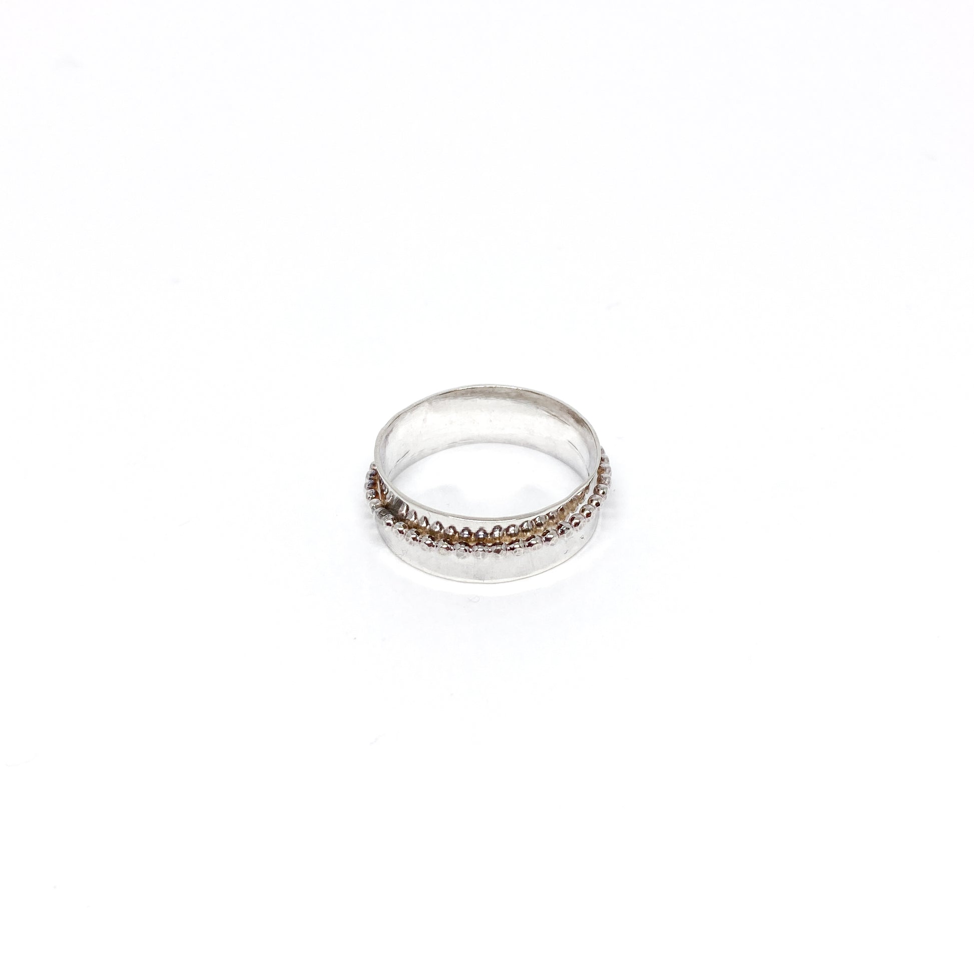Handmade hammered sterling silver spinner ring with a beaded spinning band.