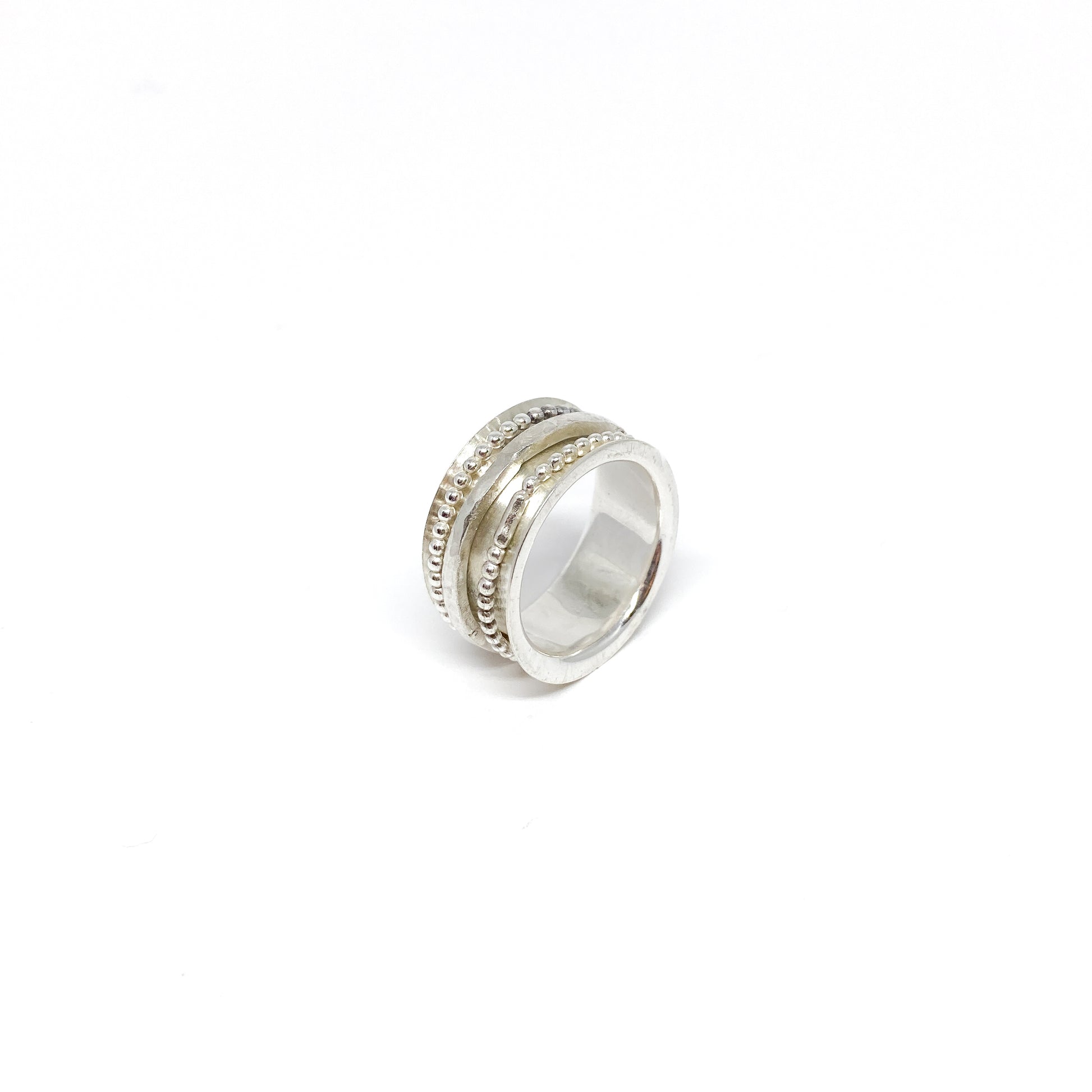 Sterling silver spinner ring with multiple textured and beaded spinning bands.
