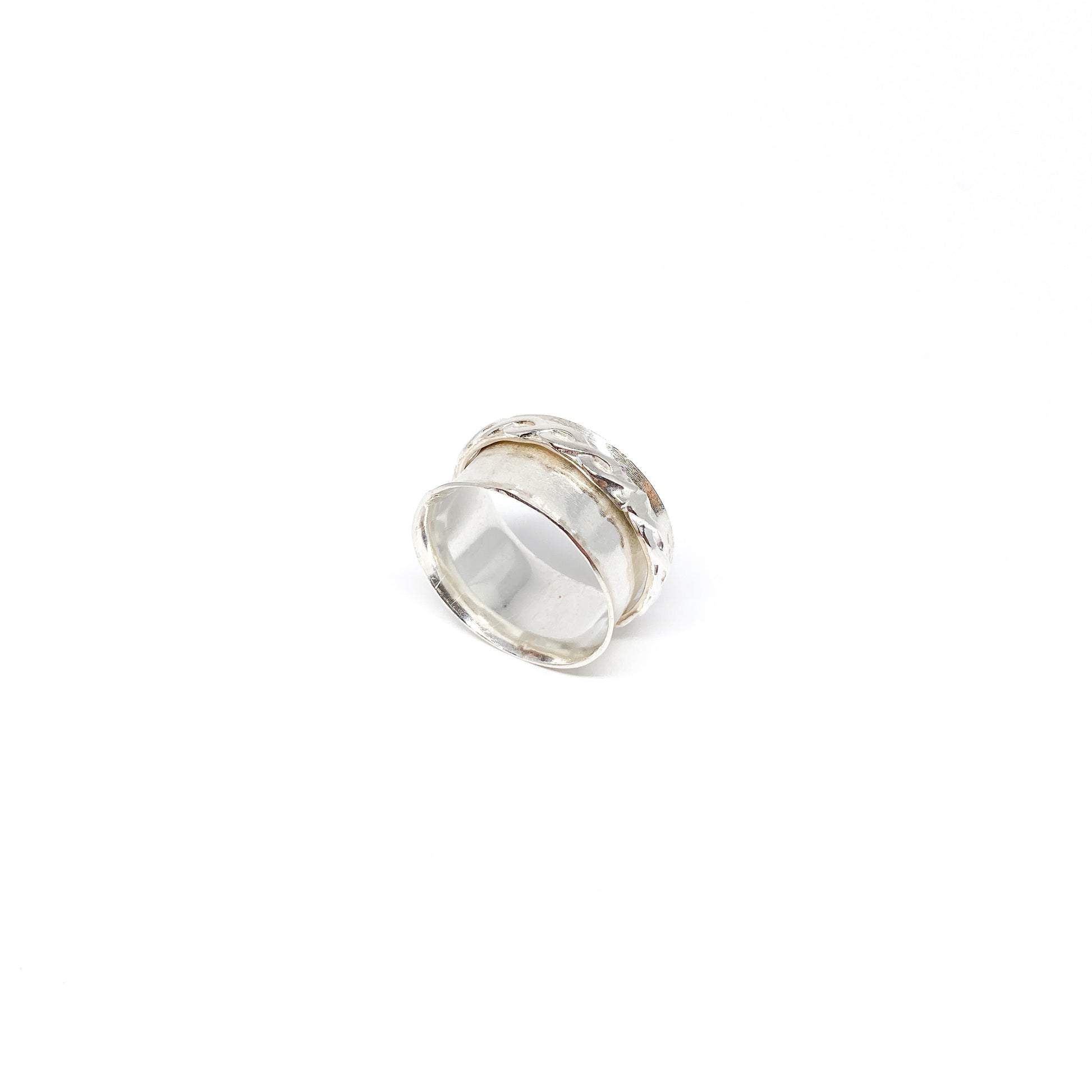 Hammered sterling silver spinner ring with a textured, movable outer band.